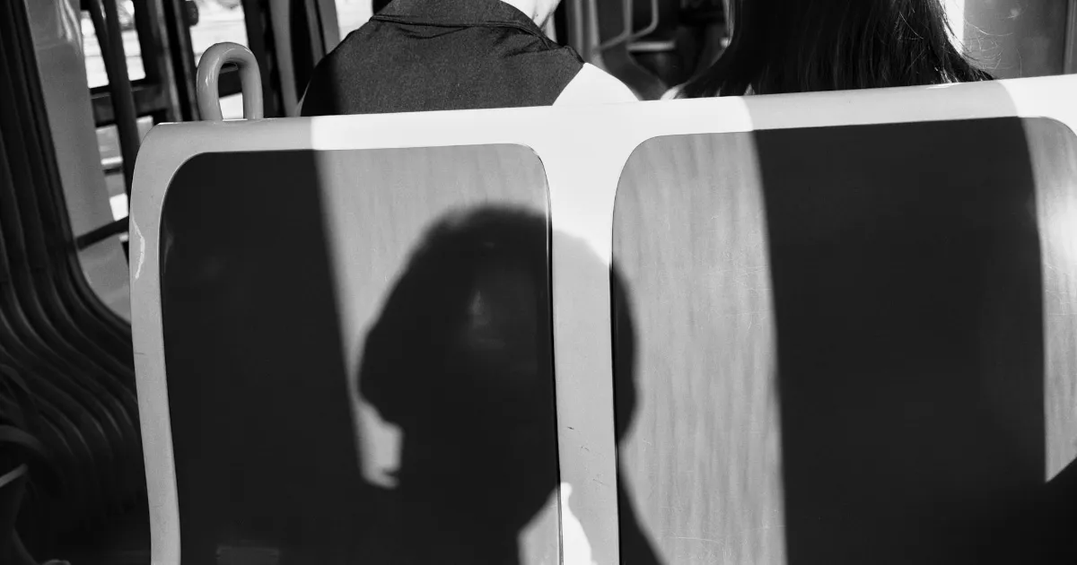 A close-up of a man’s intent gaze on his partner, her face half in shadow, the moment between them the only thing in frame