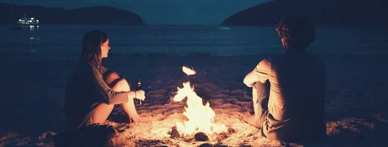 Leo man and a woman sitting near the fire