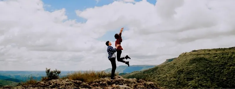 A happy couple on top of a mountain